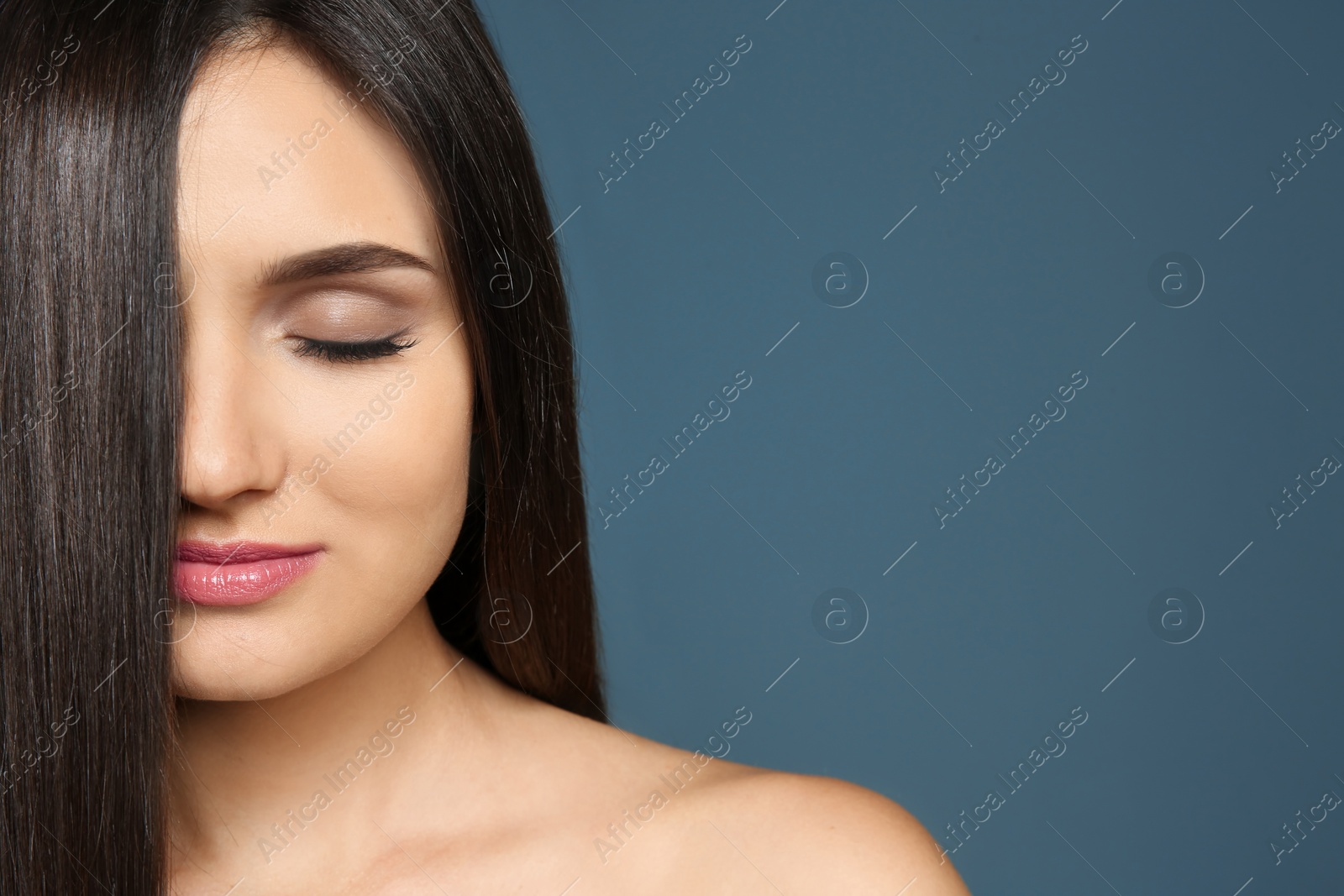 Photo of Portrait of beautiful model with gorgeous straight hair on color background