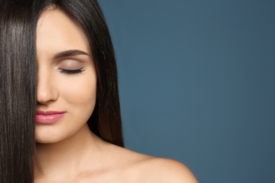 Photo of Portrait of beautiful model with gorgeous straight hair on color background