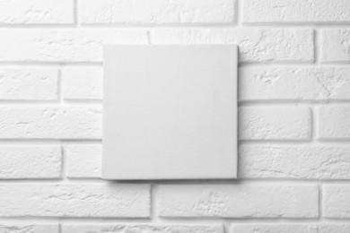 Blank canvas on white brick wall. Space for design