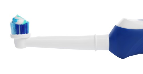 Photo of Electric toothbrush with paste on white background, closeup