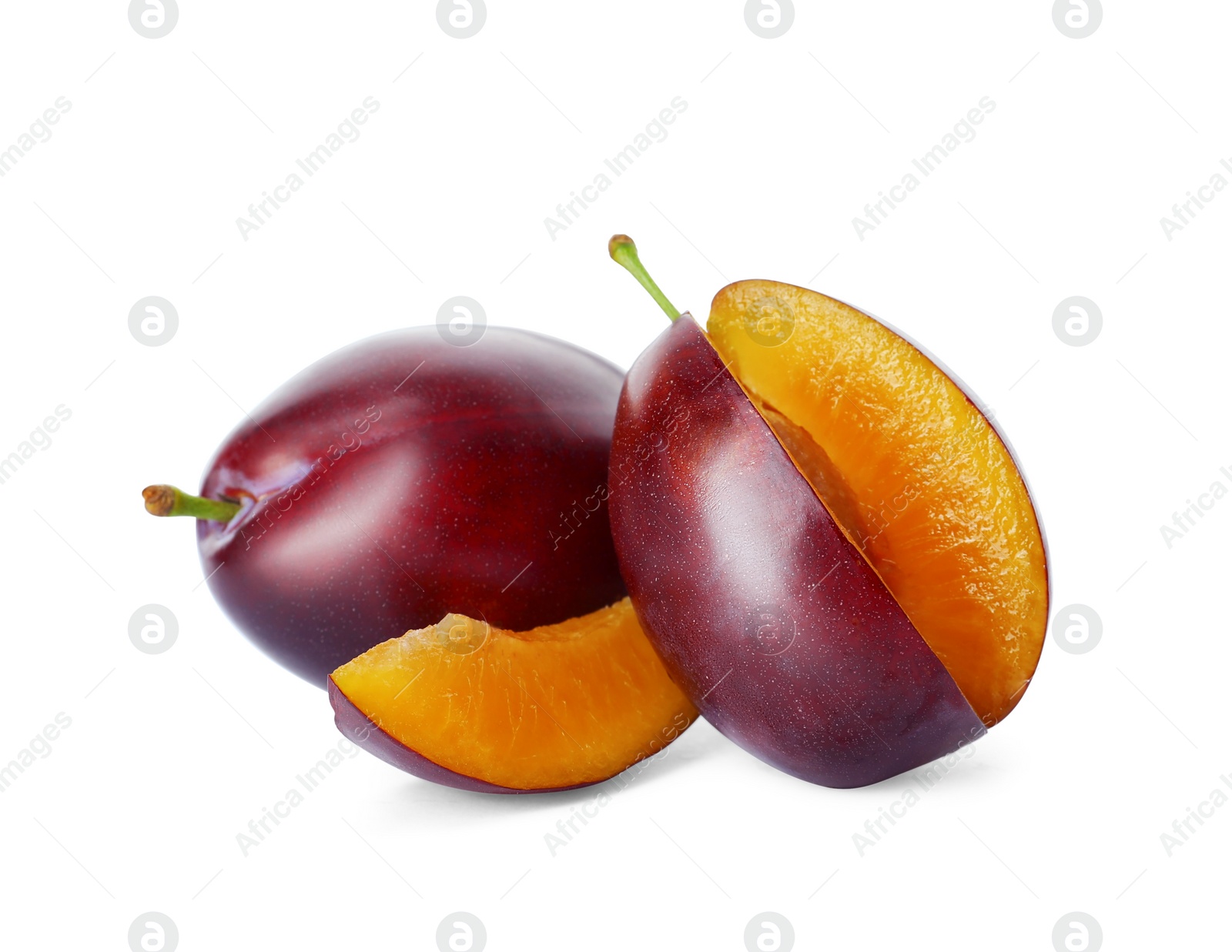 Photo of Whole and cut ripe plums on white background