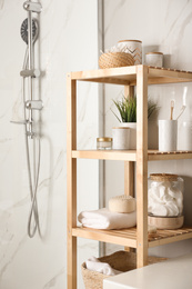 Shelving unit with toiletries in bathroom interior