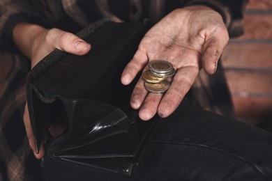 Image of Poor woman with wallet counting coins, closeup