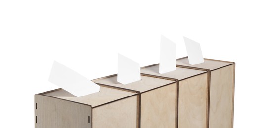 Photo of Wooden ballot boxes with votes isolated on white