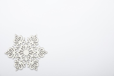 Photo of Beautiful decorative snowflake on white background, top view. Space for text