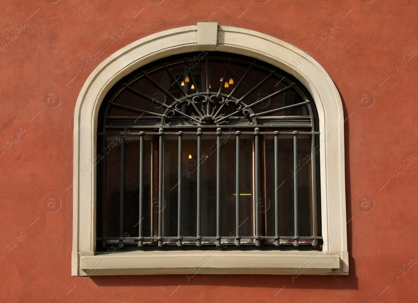 Photo of Beautiful arched window with grills in building outdoors