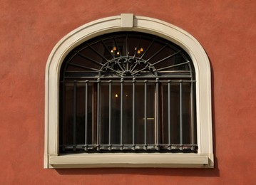 Beautiful arched window with grills in building outdoors