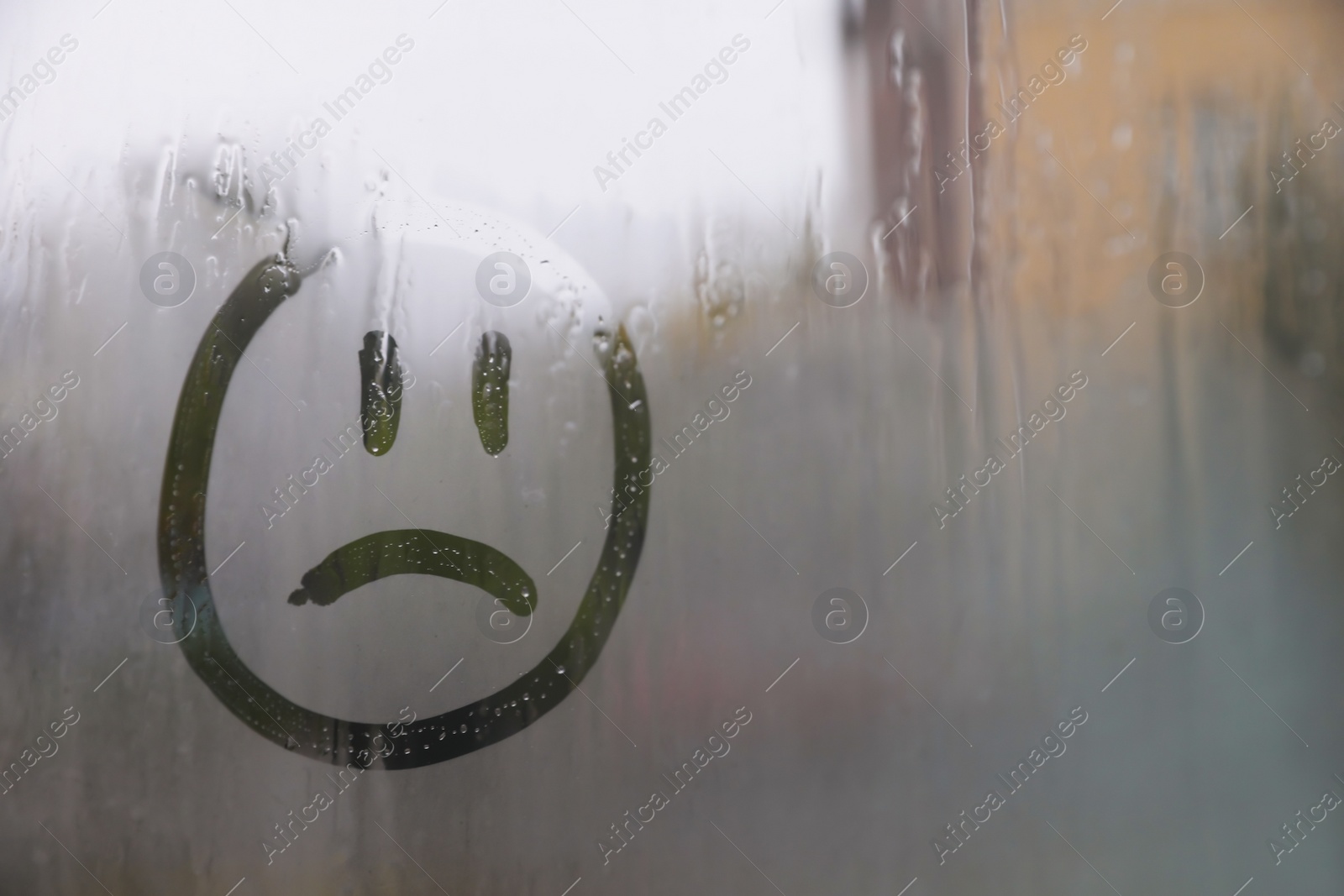 Photo of Sad face drawn on foggy window, space for text. Rainy weather