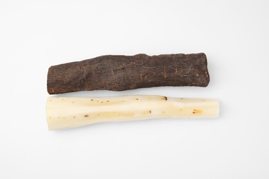 Photo of Cut raw salsify roots on white background, flat lay