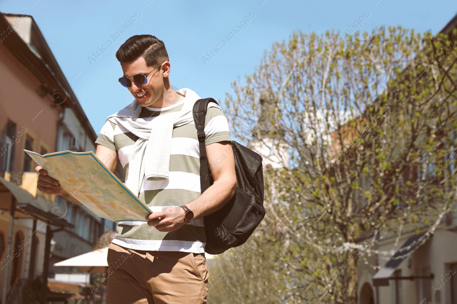 Photo of Tourist with map walking on city street