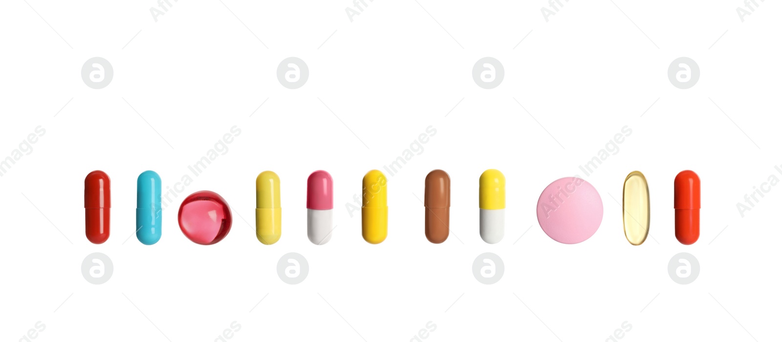 Image of Set of different color pills in row isolated on white