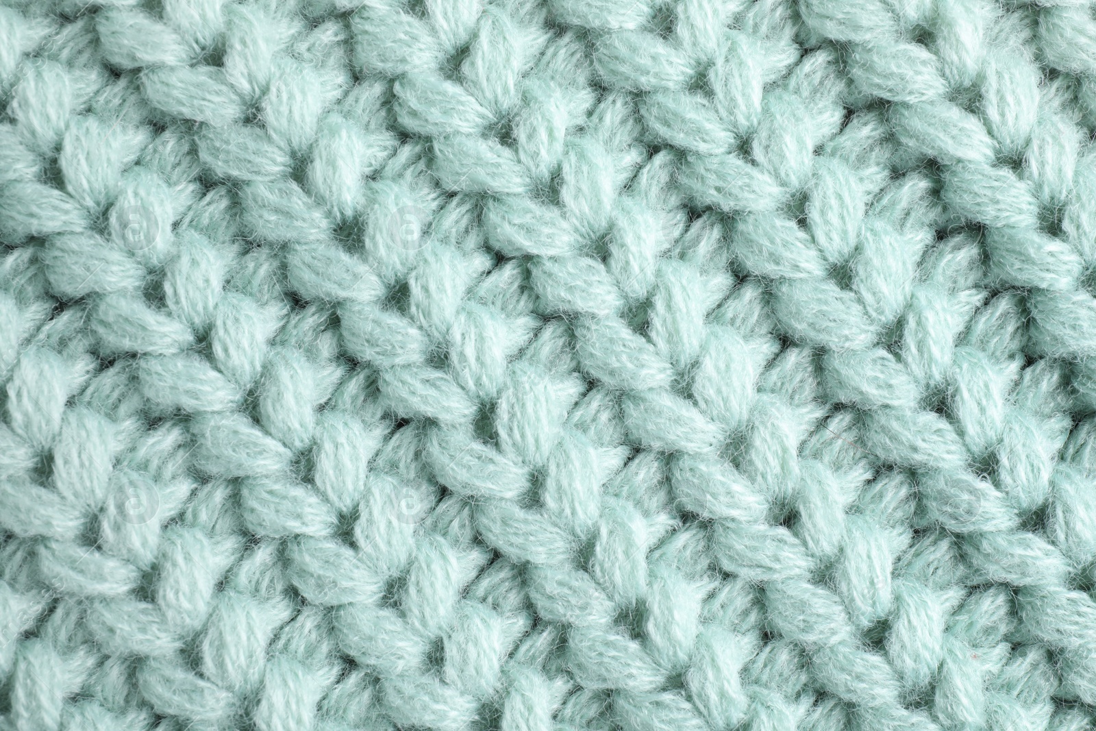 Photo of Warm knitted sweater as background, closeup view