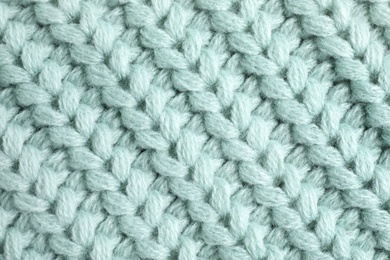 Warm knitted sweater as background, closeup view