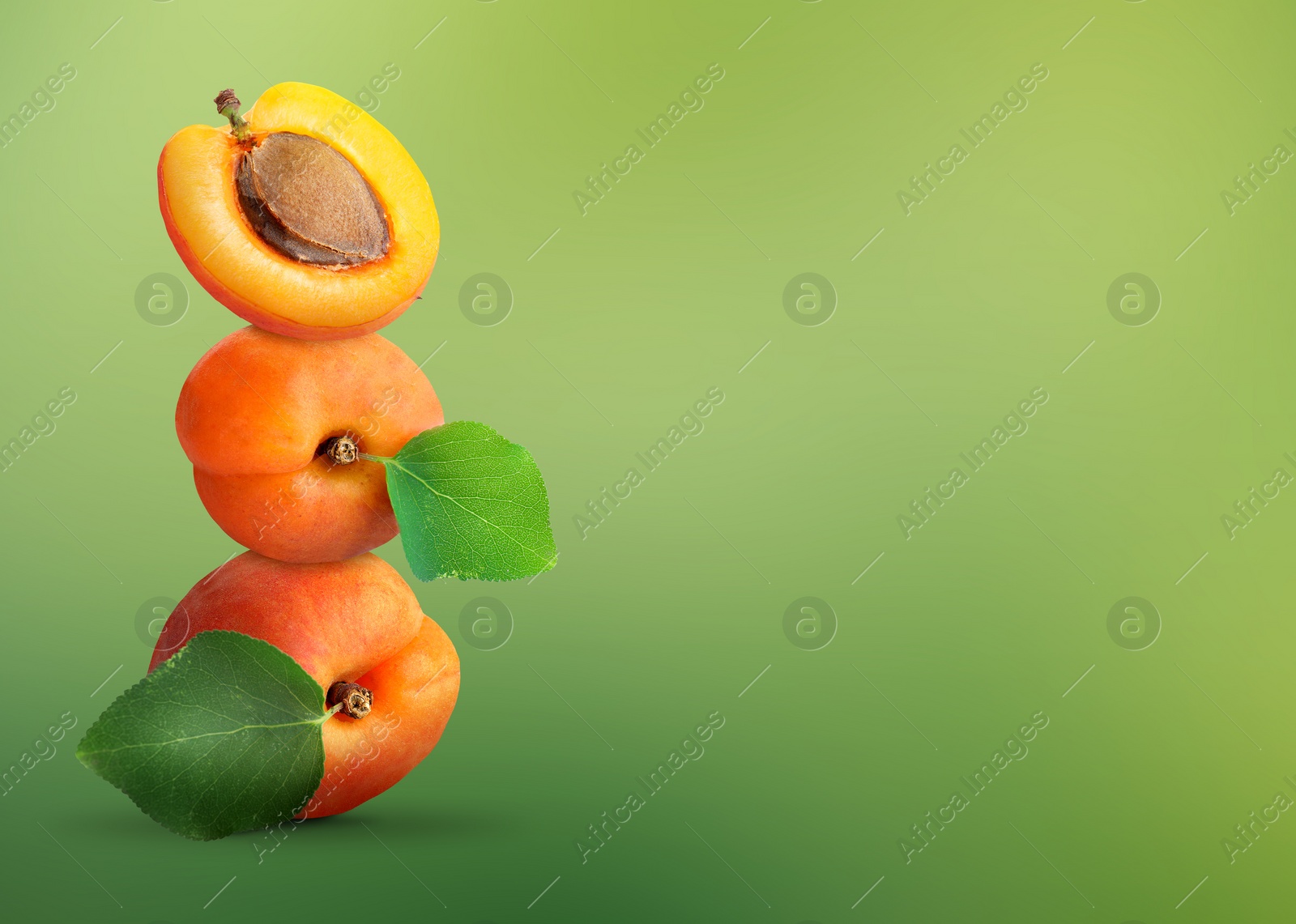 Image of Stack of fresh ripe apricots on green gradient background. Space for text