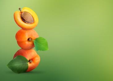 Image of Stack of fresh ripe apricots on green gradient background. Space for text