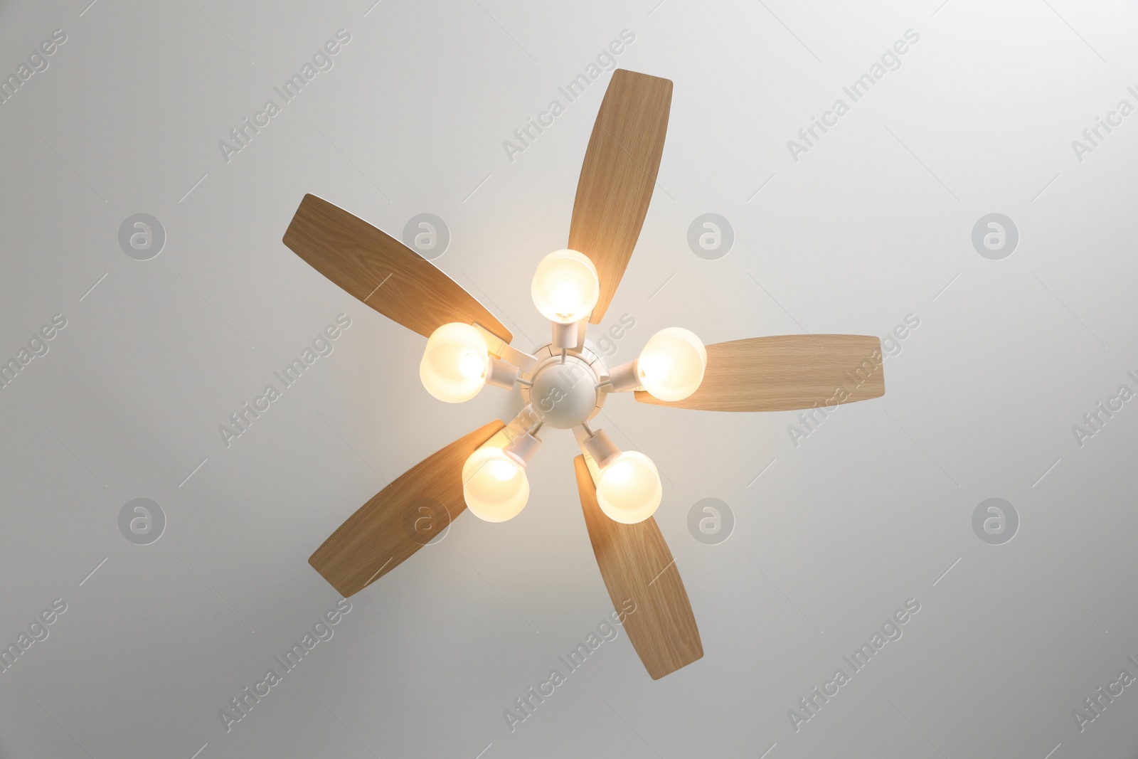 Photo of Modern ceiling fan with lamps indoors, bottom view