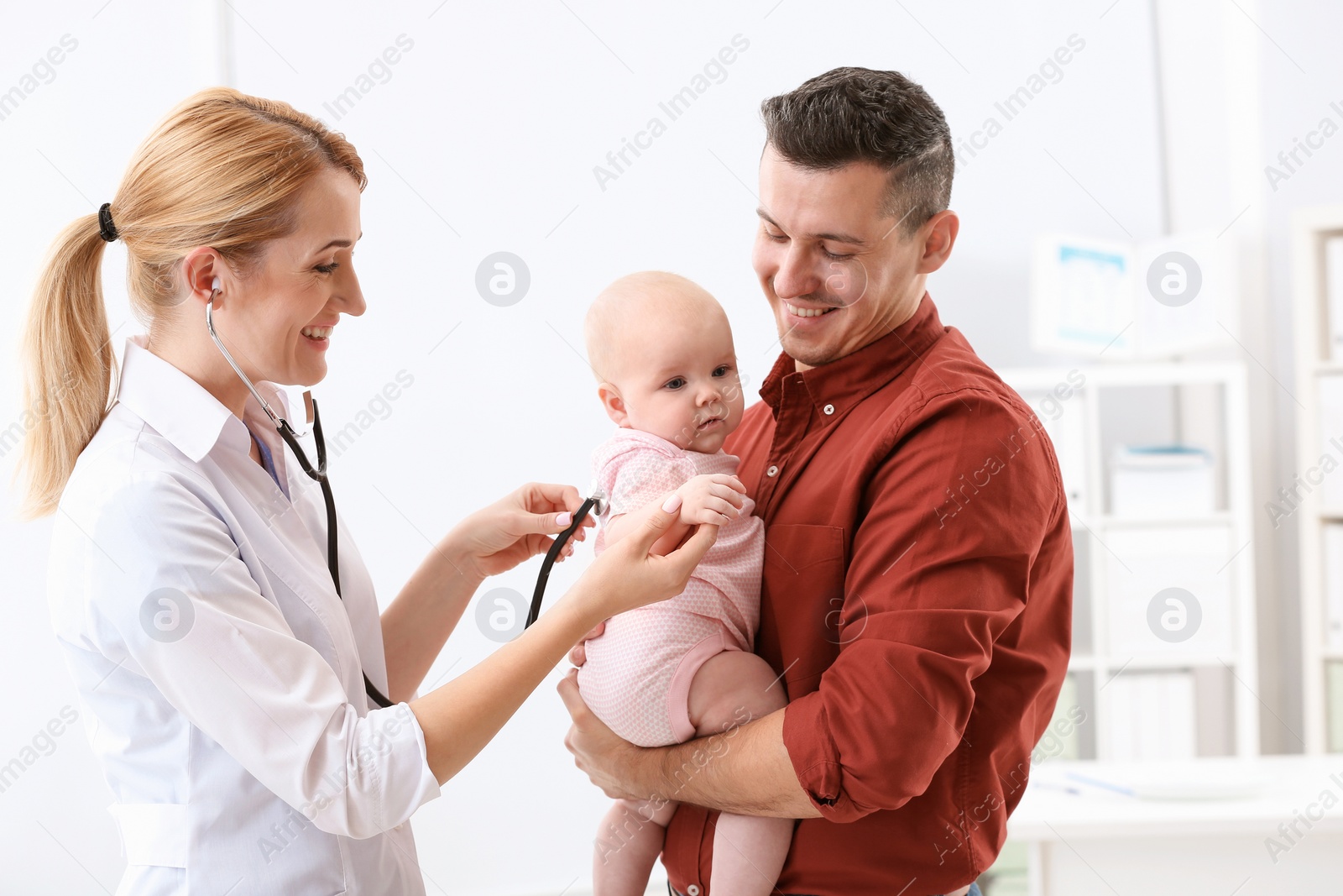 Photo of Man with his baby visiting children's doctor in hospital