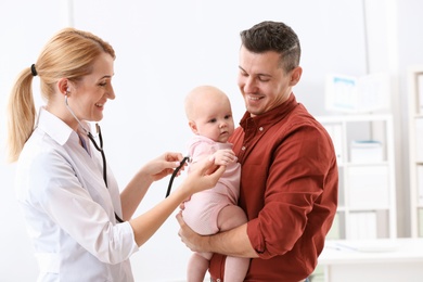 Man with his baby visiting children's doctor in hospital