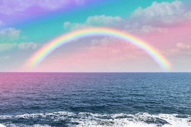 Image of Beautiful view of colorful rainbow in sky over sea