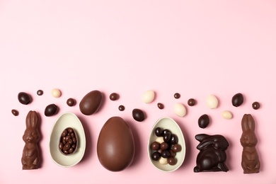 Photo of Flat lay composition with chocolate Easter eggs and space for text on color background