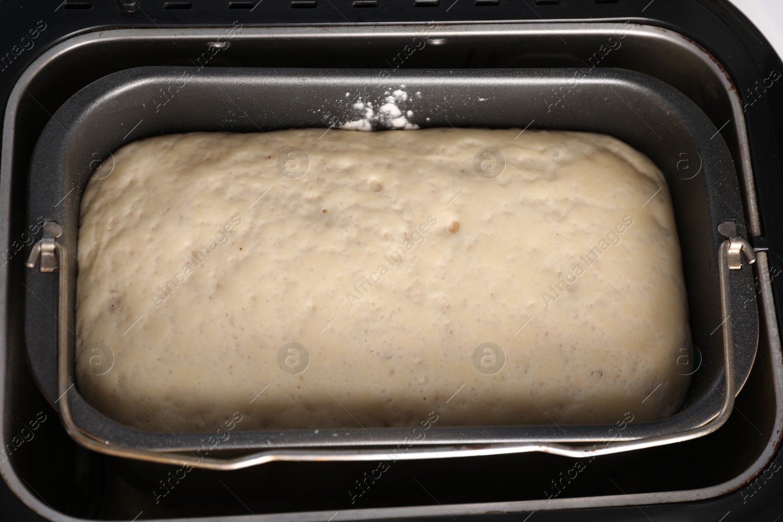 Photo of Modern bread maker with raw dough, above view