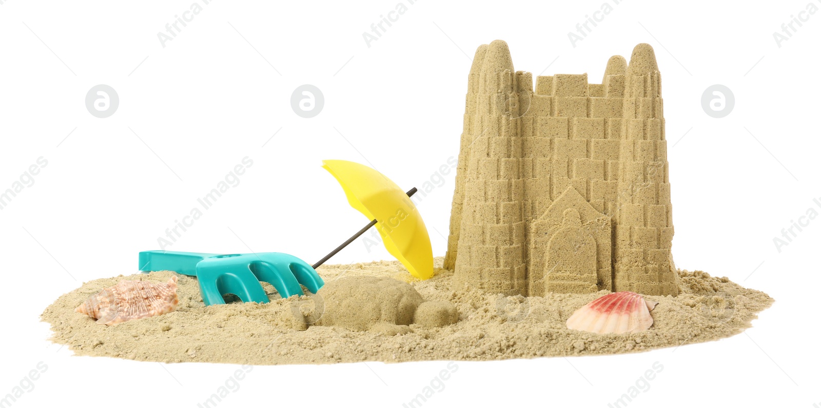 Photo of Pile of sand with beautiful castle, shells and plastic toys isolated on white