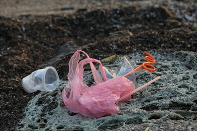 Plastic garbage at beach, closeup. Environmental pollution concept