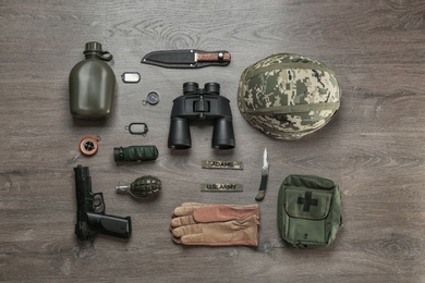 Set of military equipment on wooden background, flat lay