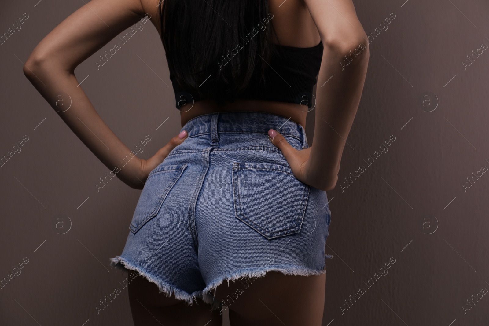 Photo of Closeup view of slim woman on beige background. Cellulite problem concept