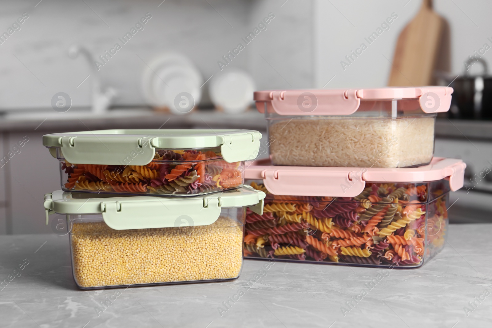 Photo of Many boxes with different food on table in kitchen