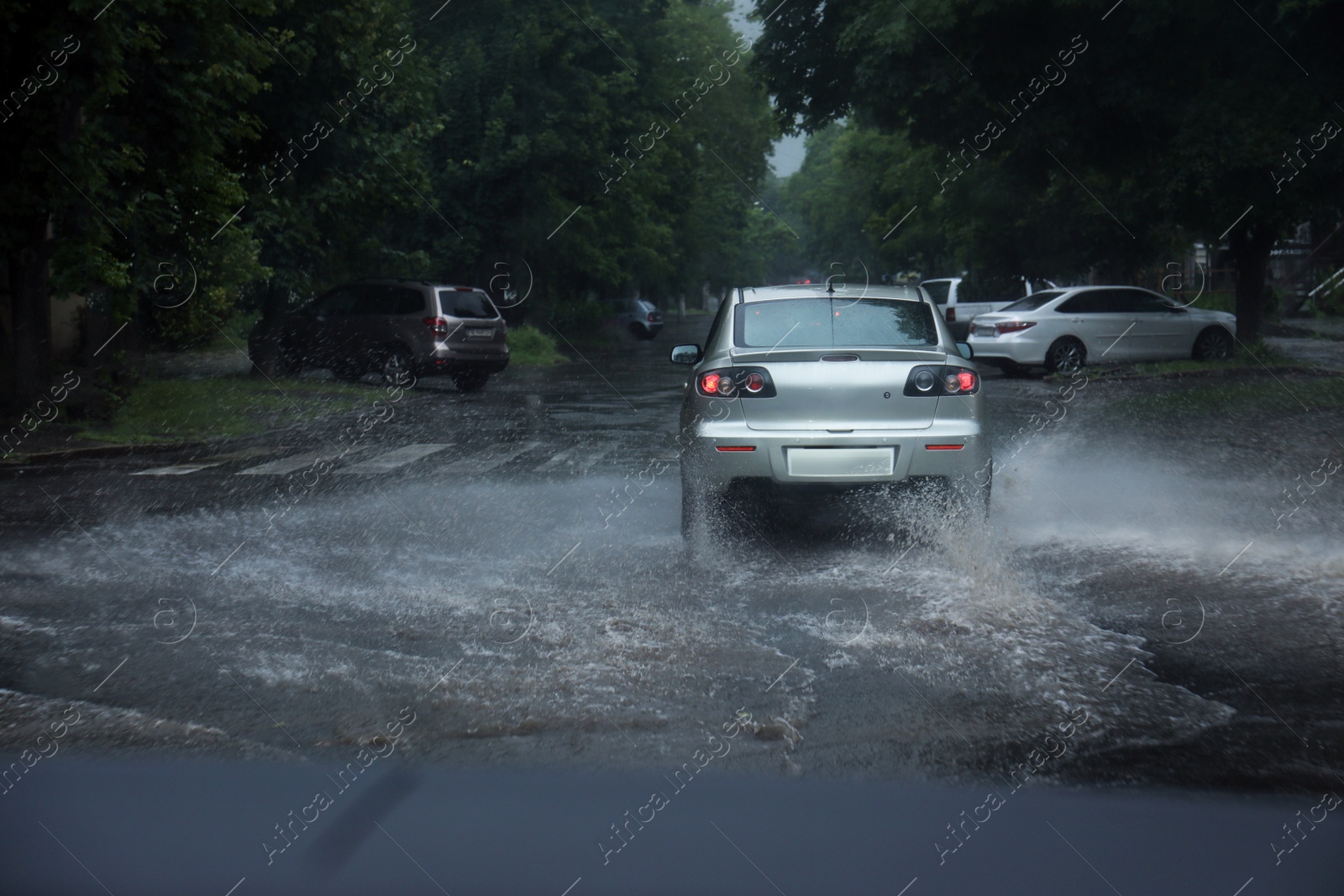 Photo of View of road with cars in evening. Rainy weather