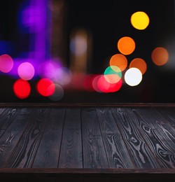 Empty black wooden surface against blurred background. Space for design