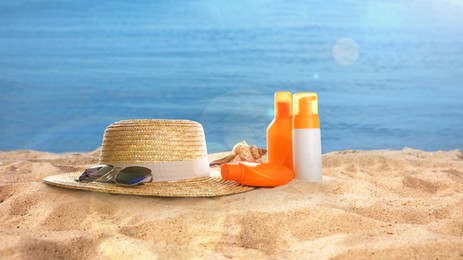 Hat with sunglasses and cosmetics on sunny ocean beach, banner design. Summer vacation