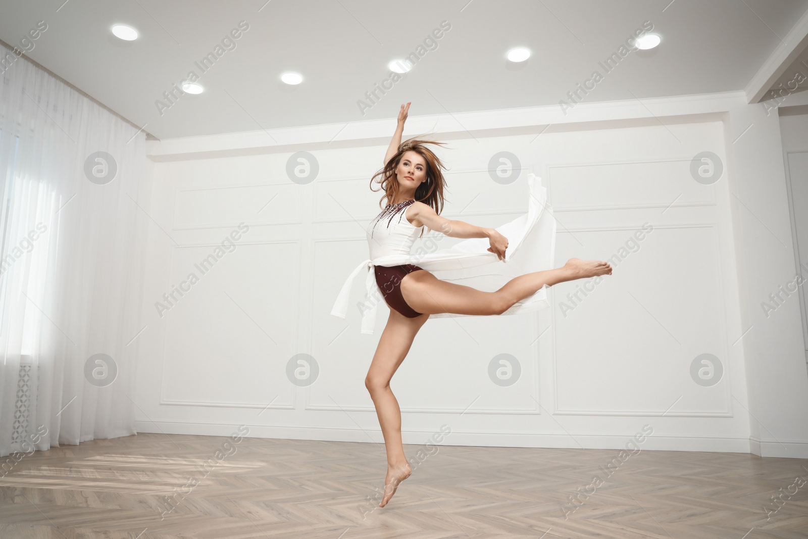 Photo of Beautiful professional dancer practicing moves in studio