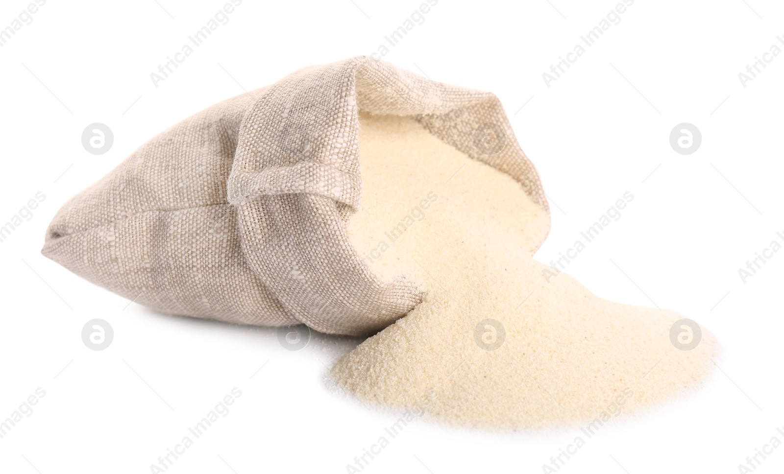 Photo of Uncooked organic semolina in bag on white background