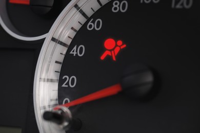 Closeup view of dashboard with warning icon check airbag system in car