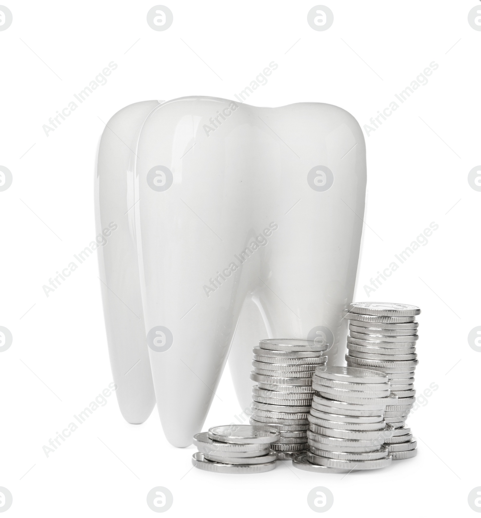Photo of Ceramic model of tooth and coins on white background. Expensive treatment