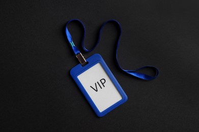 Photo of Plastic vip badge on black background, top view