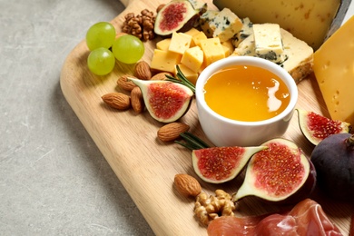 Photo of Set of different snacks with ripe figs served on board