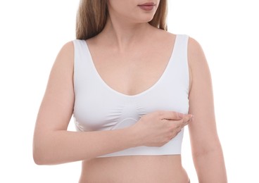 Photo of Mammology. Young woman doing breast self-examination on white background, closeup