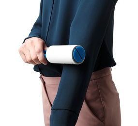 Young woman cleaning blouse with lint roller on white background