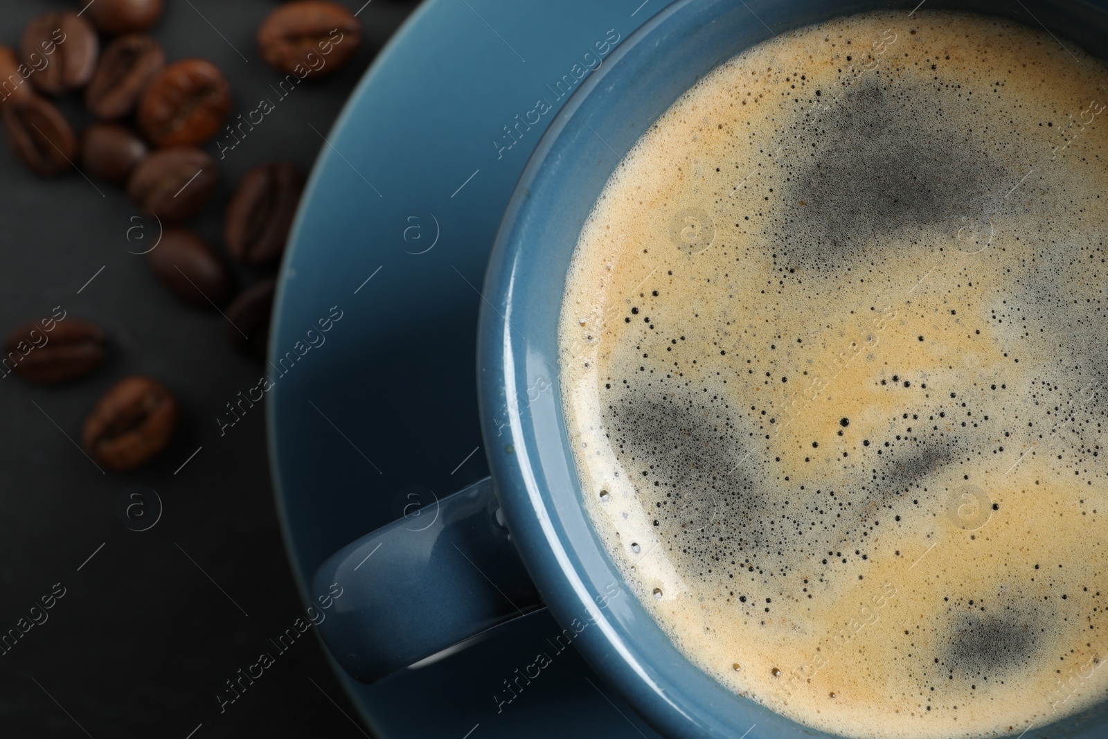 Photo of Cup of aromatic coffee on grey table, top view. Space for text