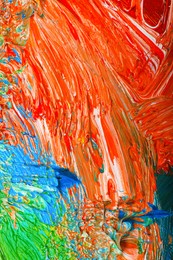 Photo of Closeup view of artist's palette with mixed bright paints as background