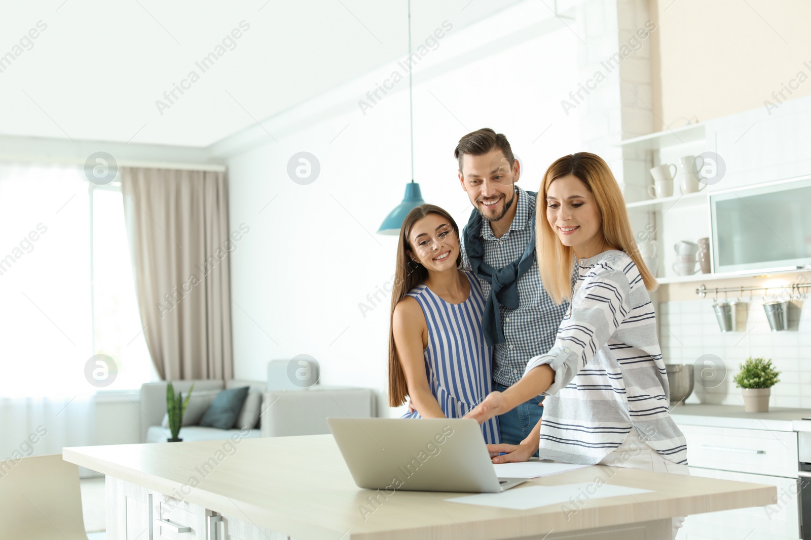 Photo of Female real estate agent working with couple, indoors