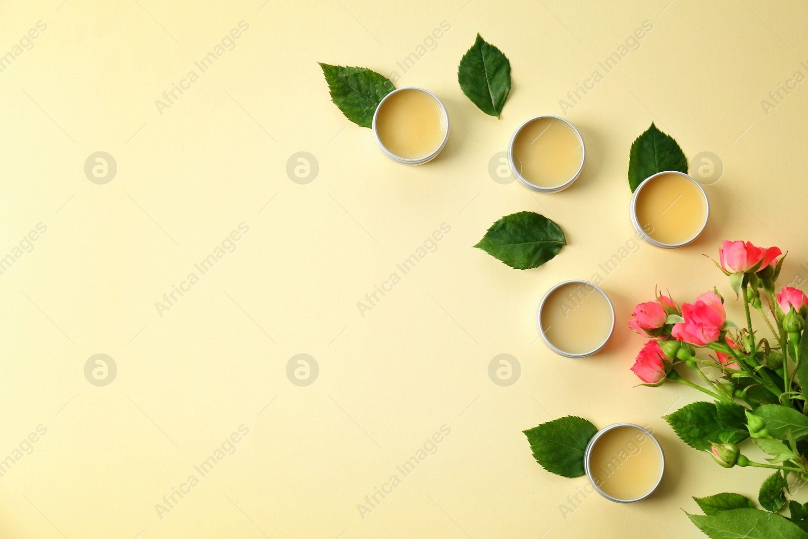 Photo of Flat lay composition with hygienic lip balms on color background