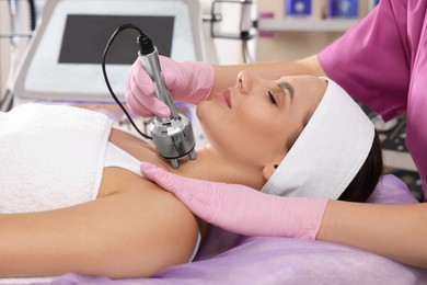 Young woman undergoing cosmetic procedure in beauty salon. Microcurrent therapy