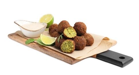 Photo of Delicious falafel balls, sauce, herbs and lime isolated on white