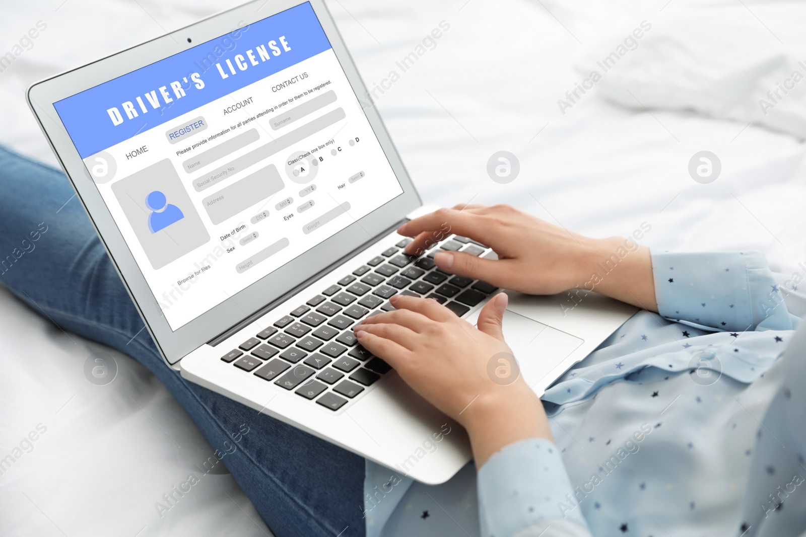 Image of Woman filling in driver's license form online on website using laptop, closeup