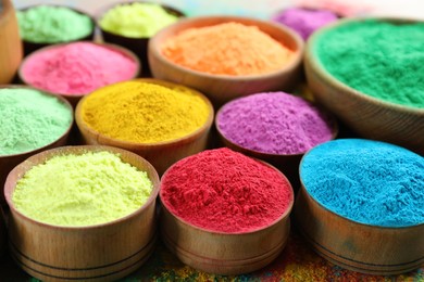 Photo of Colorful powder dyes as background, closeup. Holi festival