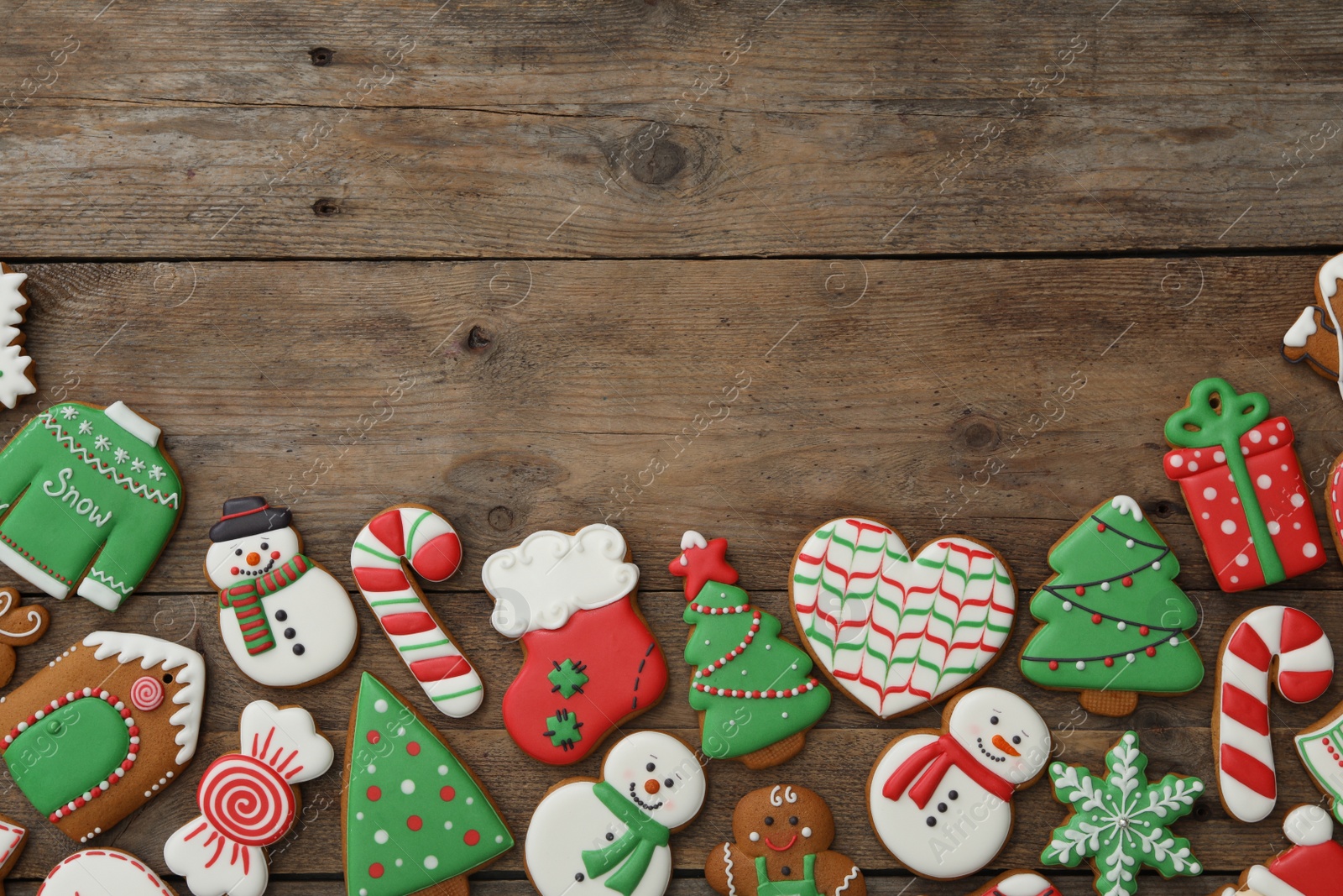 Photo of Many different delicious Christmas cookies on wooden table, flat lay. Space for text